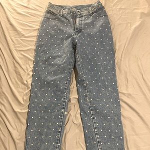 High waist slim leg jeans covered in rhinestone grommets, fully lined inside